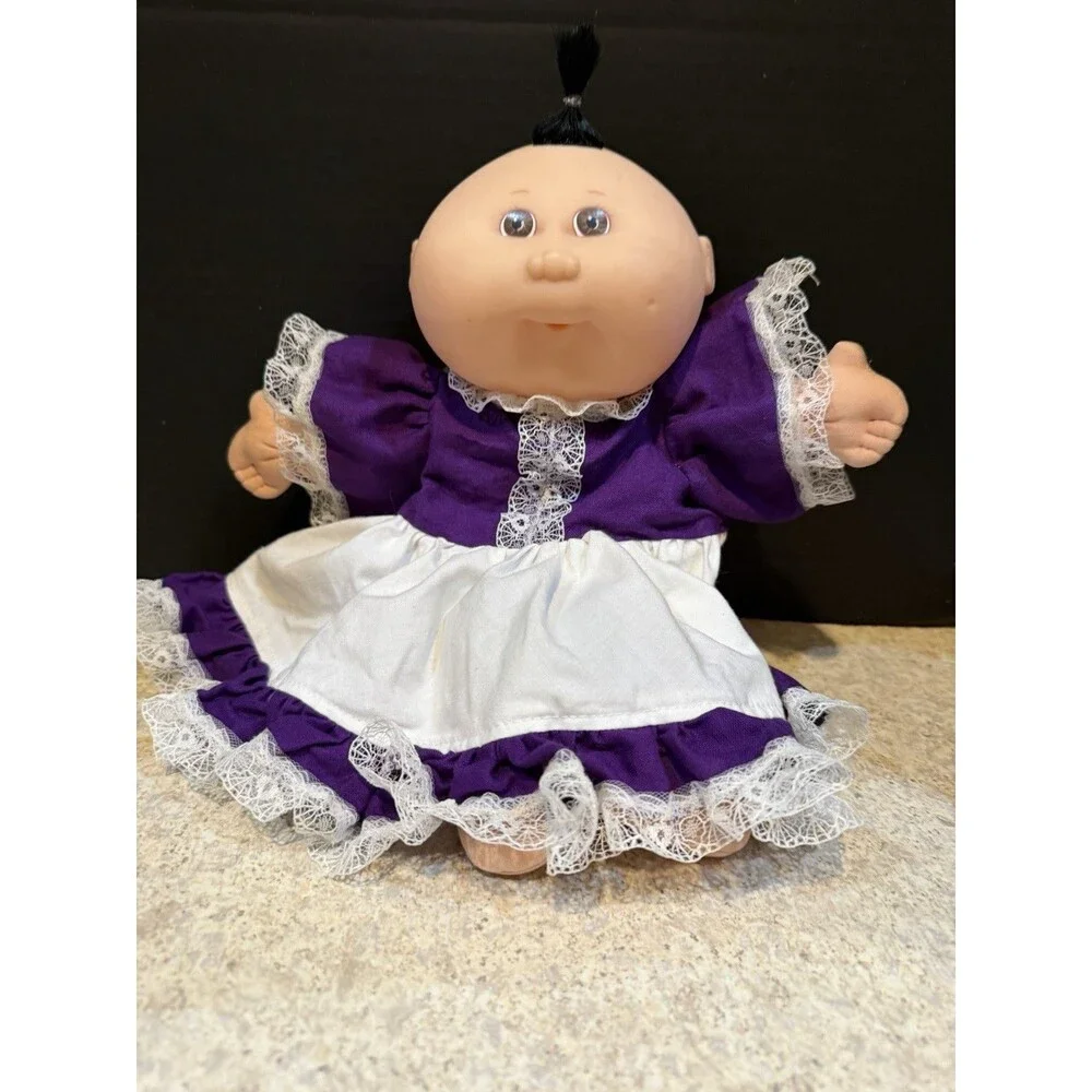 cabbage patch doll from 1990 made by mattel- purple dress